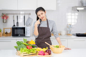Young women are happy in the modern kitchen with healthy food, healthy food ideas and weight loss, copy space.