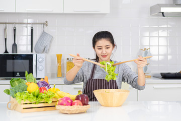 Beautiful Asian women looking for fruits and vegetables, healthy food ideas and weight loss.