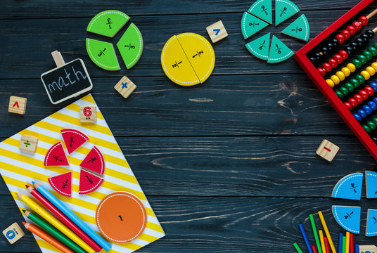 Creative Сolorful math fractions on dark background. Interesting funny math for kids. Education, back to school concept. Geometry and mathematics materials. Flat lay, top view