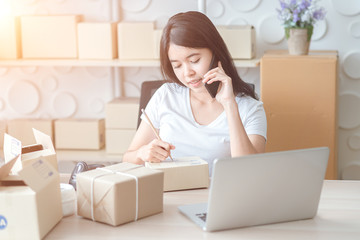 Asian women at the office of the online shopping business in the home office. Start a business, a business entrepreneur. SME, concept of online business