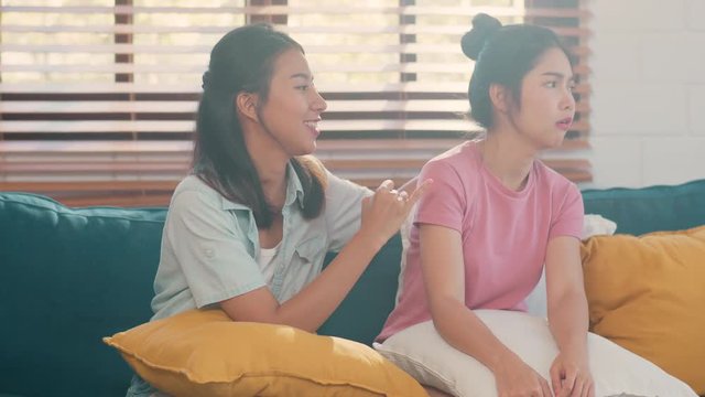 Young Lesbian lgbtq Asian women couple angry conflict together at home. Asia female sad flight annoyed on sofa in living room, teenager young girl upset, break up, unhappy concept. Slow motion.