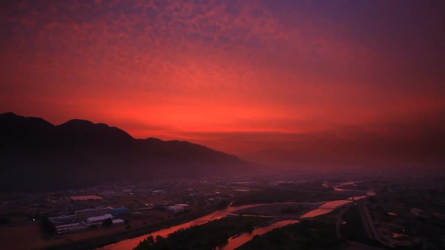 Panning shot of Chikuma River in mountain landscape at sunrise, Japan
