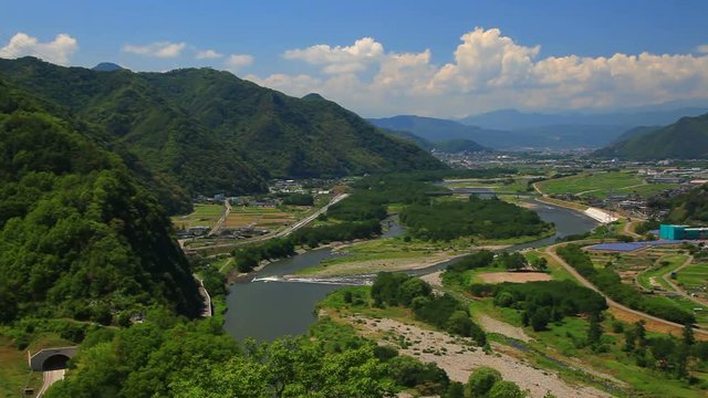 Panning shot of Chikuma River in mountain landscape, Japan