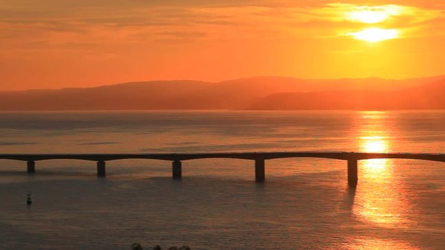 Panning shot of sunrise over Kouri Ohashi bridge, Nakijin, Kunigami