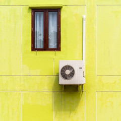 Air conditioner compressor installed on concrete wall of the green building. background and...