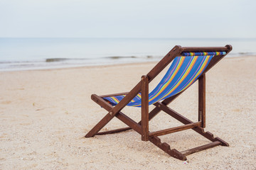 Vintage wooden bed at the beach with copy space. Concept of vacation, leisure, holiday and relaxing. Processed in vintage color tone