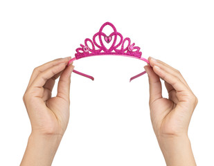 Hand holding Crown of a princess isolated on white background © cloud7days
