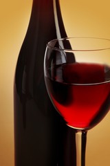Glass Of Wine With Wine Bottle Close-up