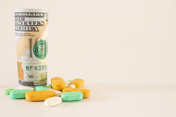 Money from the United States with vibrantly colored medicines on a neutral white background. Concept of health cost. Concept of drug trafficking.
