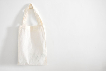 White cloth bag on a white wall background