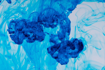 Cloud of ink in water on white background.