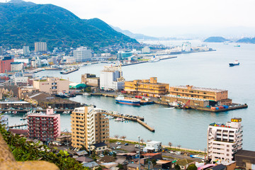 Fototapeta na wymiar Kitakyushu, Japan - 20 November 2016: A view of Mojiko Port, a large port city and commercial center Viewed from the Kanmon Strait and Kanmonkyo Bridge