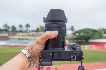 Male hand holding a digital camera.