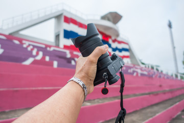 Male hand holding a digital camera.