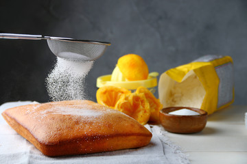 orange cake or bread with ingreients on table