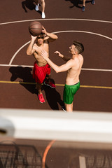 Fototapeta na wymiar overhead view of basketball players with ball at basketball court
