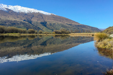 Snow capped Southern Alps overlooking beautiful lake scenes in the South Island New Zealand