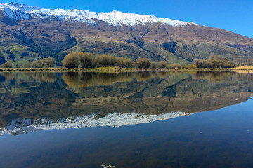 Snow capped Southern Alps overlooking beautiful lake scenes in the South Island New Zealand