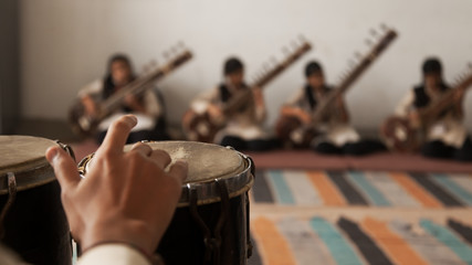 A Band of musicians playing Bongo and Sitar.