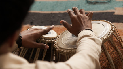 Man playing a Drum or Indian Classical Musical Instrument Tabla - obrazy, fototapety, plakaty