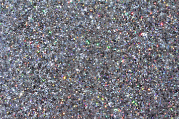 Defocused macro abstract background of sparkling silver glitter texture