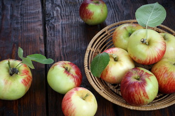 apples in a basket on a dark wooden table