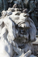Group of Pigeons on The marvellous lion statue at Piazza Duomo of Milano Italy, dirty from bird pooping shit on attractive sculpture art, travel destination backgrounds