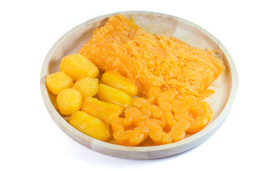 Close up Amazing traditional Thai desserts call Foi Thong, Thong yip and Thong Yod isolated on white background with clipping path. Thai sweet dessert made from eggs, coconut and bean cooked in syrup.
