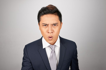 Asian Businessman looking totally shocked