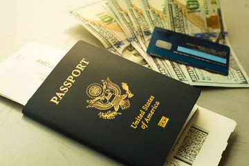 USA passport with cash and credit card at airport.