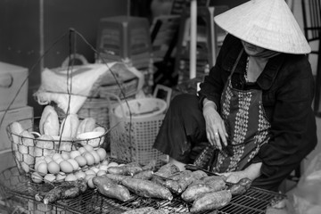 Asian Vietnamese woman selling food on the street.