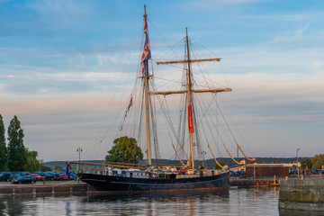 Fototapeta na wymiar Honfleur, France - 06 01 2019: Beautiful Wooden boat with two masts
