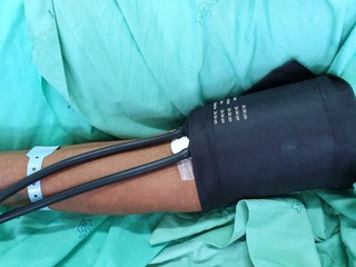 Blurred image of measuring blood pressure of patient on the bed in hospital, Health and Medical...