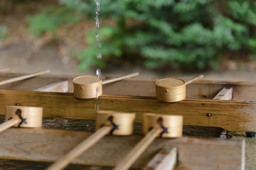 Dipping cups for cleansing ceremony, hand wash pavilion before enter the shrine gate at Meiji jingu in Tokyo, Japan. religion and culture
