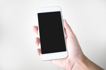 Young hands holding a smart phone on a white background