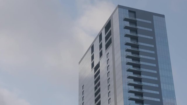 Clouds pass over tall building in Austin, Texas