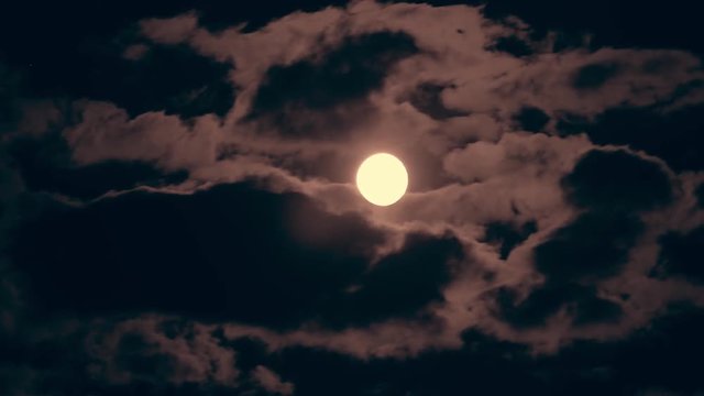 Timelapse of Full moon and clouds at night.