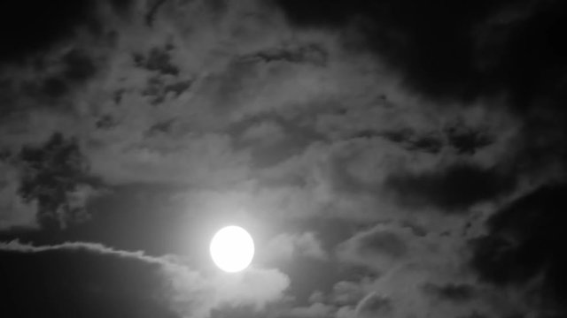 Timelapse of Full moon and clouds at night.