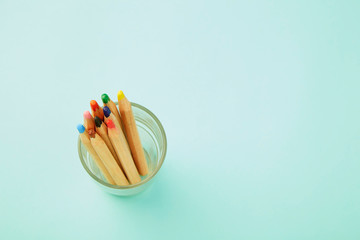 Colorful pencils on pastel pale blue