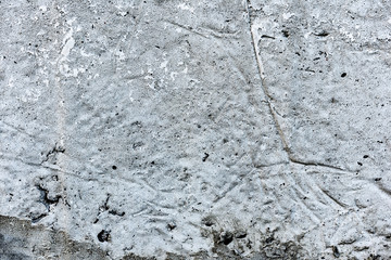 Texture of a concrete wall with cracks and scratches which can be used as a background