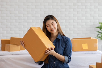 SME entrepreneur of Young Asian women working with laptop for Online shopping at home,Cheerful and Happy with box for packaging in home,Own Business Start up for Business Online and Online shopping