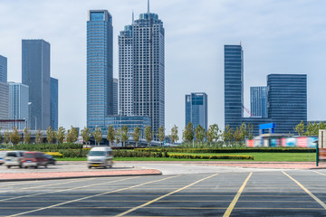 Fototapeta na wymiar empty car park with downtown city space background