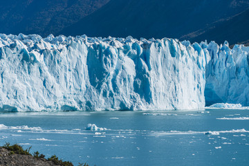 Amazing view of Perito Moreno glacier, blue ice burg glacier from peak of the mountain through the aqua blue lake in Los Glaciares National Park, Santa Cruz, Argentina, southern Patagonia ice field