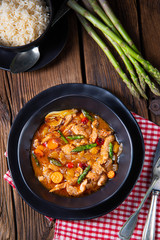 Turkey fricassee on rice with asparagus and paprika