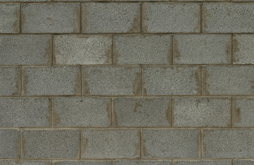 Fototapeta premium Old conctete blocks wall texture background. Exterior grey cinder block wall with lines of concrete. Cinder block wall background