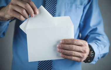 Businessman holding mail envelope. Business concept