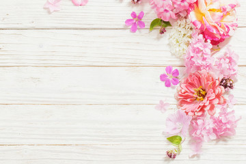 pink flowers on white wooden background