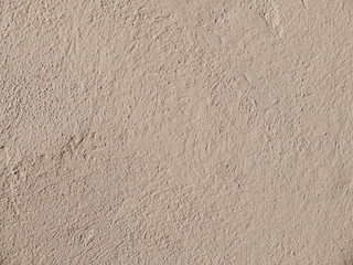 Textured grinded plaster in dark beige. Background or texture seamless pattern