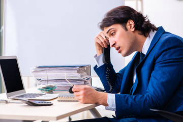 Young businessman sitting and working in the office