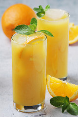 Glasses full of orange juice with ice